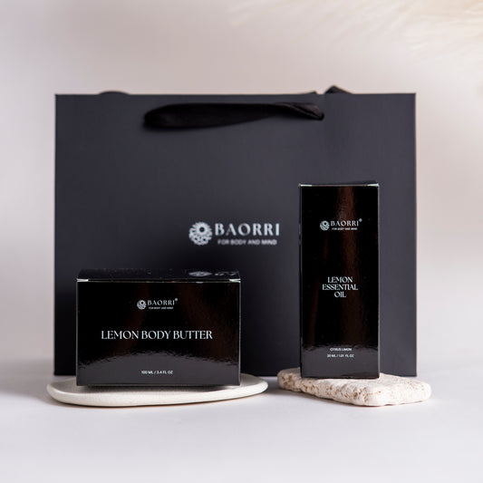 BAORRI Lemon body butter and lemon essential oil a light gray background.