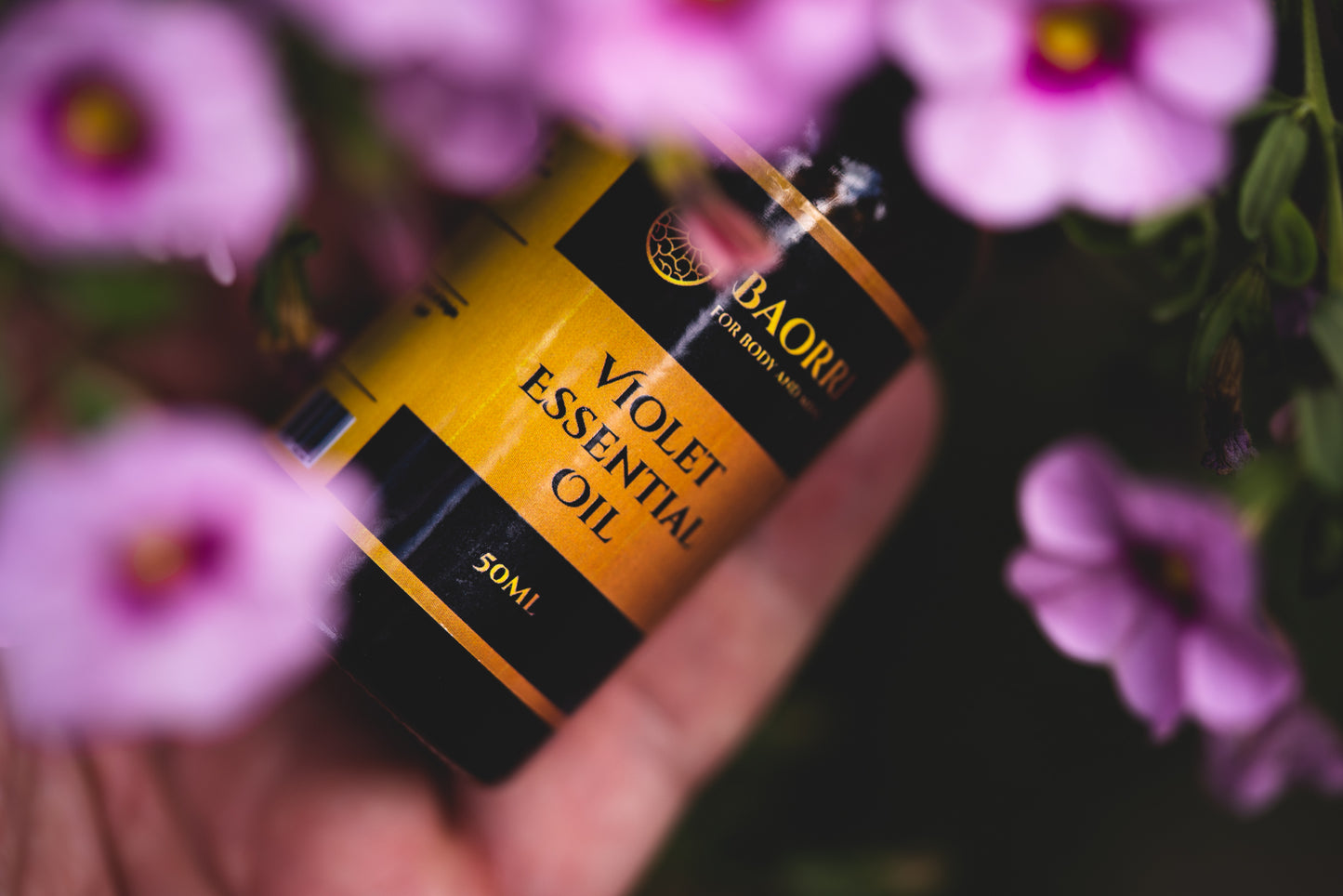 Violet Essential oil between flowers