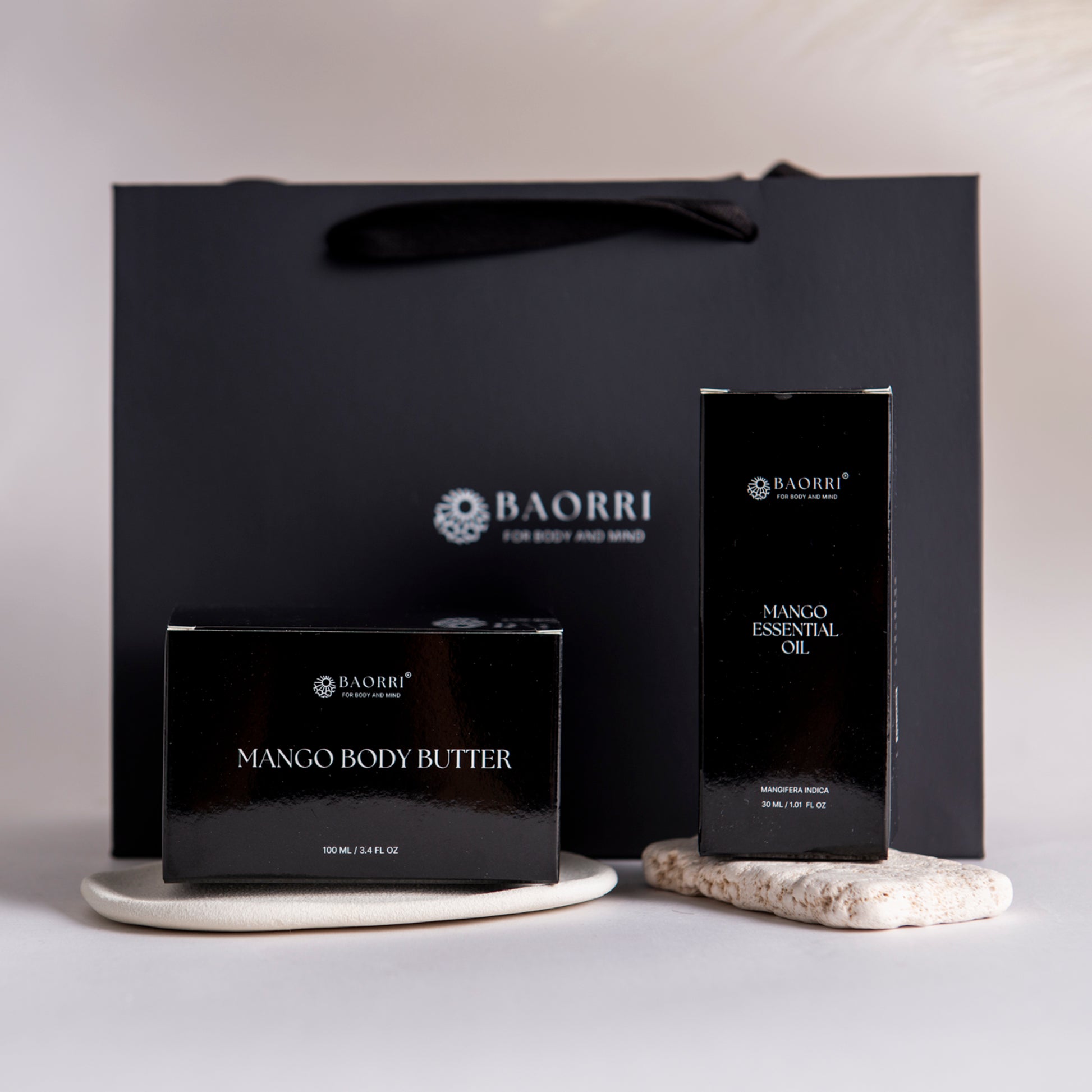 BAORRI Mango Body Butter and Essential Oil packaging on a neutral background