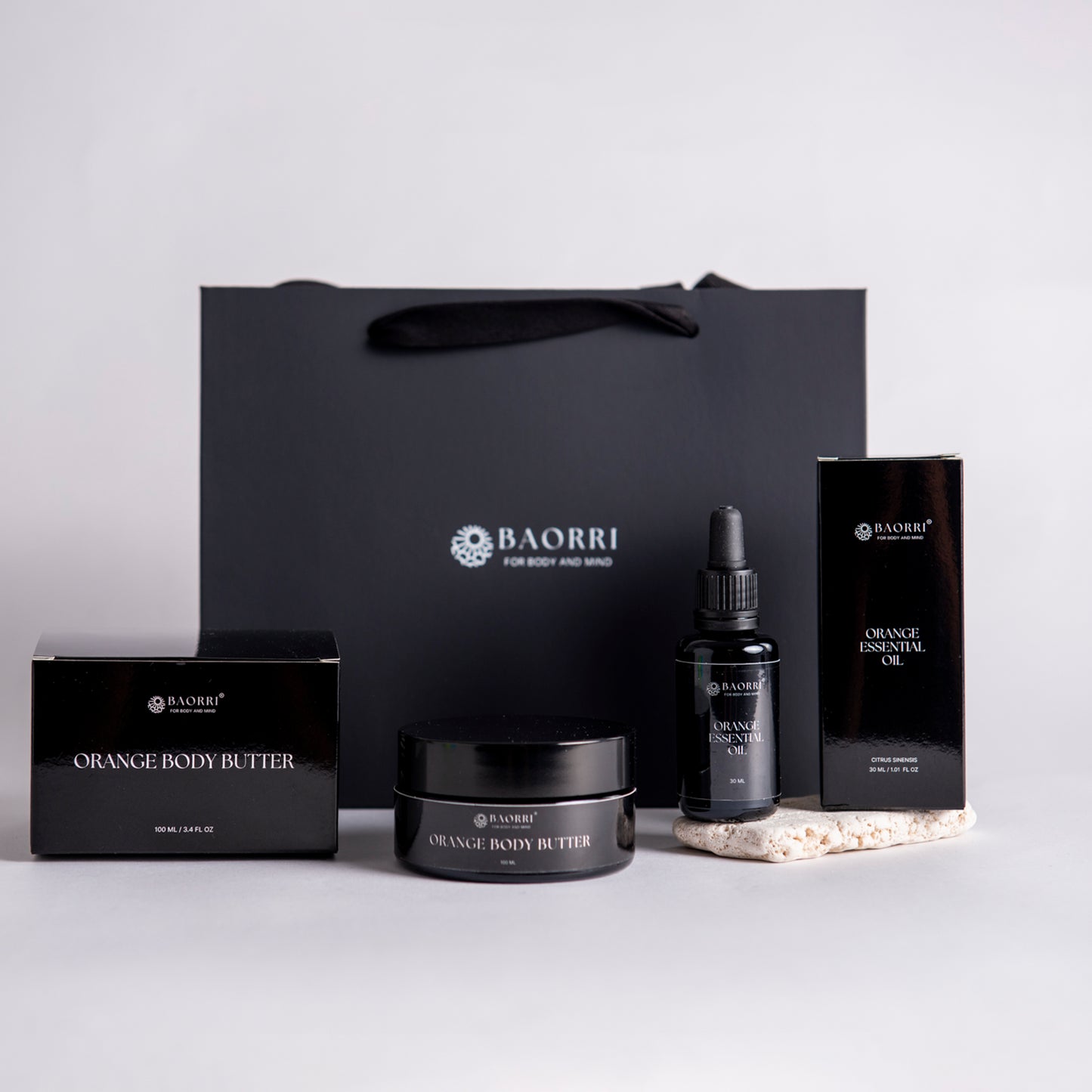 BAORRI orange essential oil and orange body butter set on a light gray background.